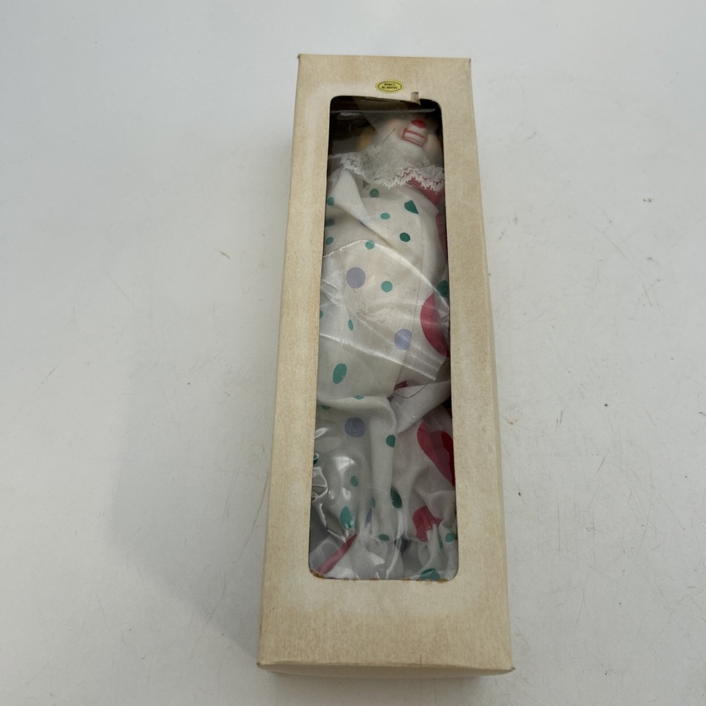 vintage-style clown doll packaged inside a tall, narrow cardboard